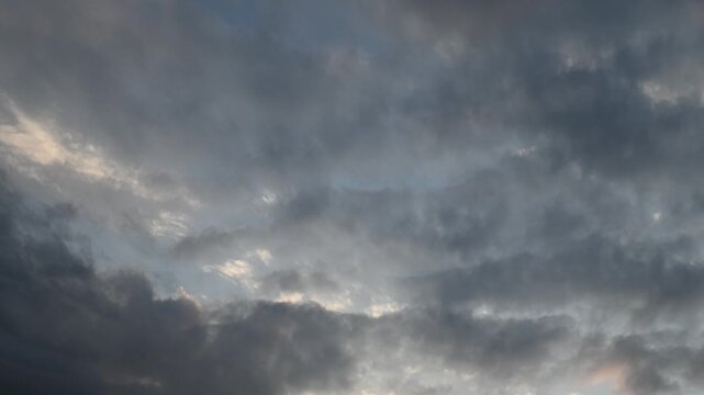 Timelapse of wispy white summer clouds gliding across a bright blue sky

