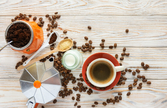 Coffee Concept Flat Lay with Geyser Coffee Maker, Cup, Milk and Beans, ground coffee on spoons, and roasted coffee beans Background