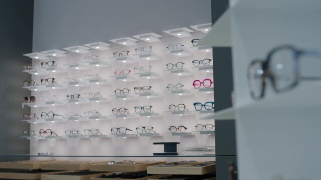 Illuminated eyewear display wall in modern optician store
