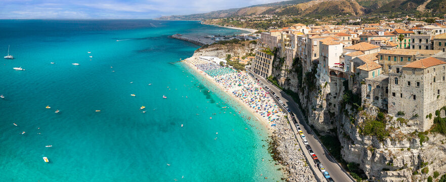 Tropea Calabria Italy aerial panoramic view iconic cliffside houses crowded beach umbrellas turquoise sea Tyrrhenian coast high resolution world print travel destination