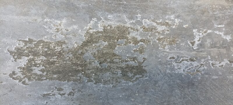 Weathered concrete texture with peeling gray surface and distressed patches, suitable for industrial backgrounds, architectural designs, grunge artwork, and construction concepts