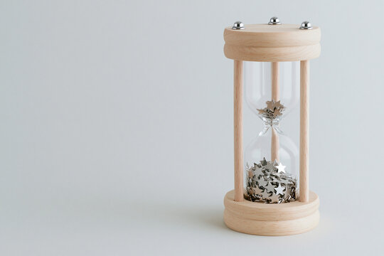 Hourglass filled with metallic stars instead of sand time and wonder