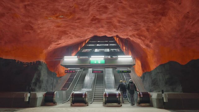 Explore the captivating design of an underground metro station featuring striking rock formations and modern escalators. A blend of natural beauty and urban architecture creates a unique atmosphere fo