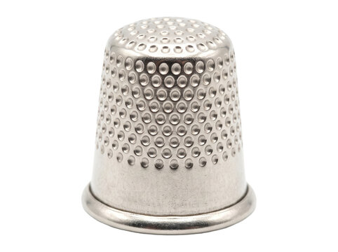Metal sewing thimble placed upright on transparent background, close up showing textured dimples and rim. studio lighting emphasizes steel finish for sewing, craft, and tailoring concept.
