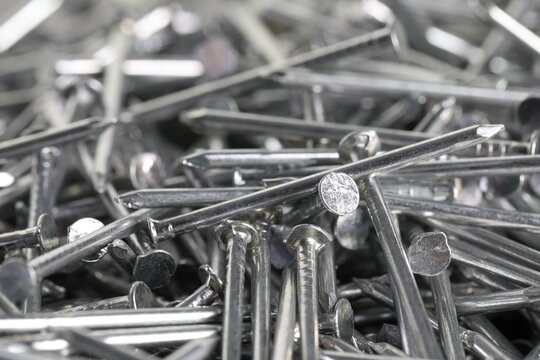 Many shiny metal nails as background, closeup