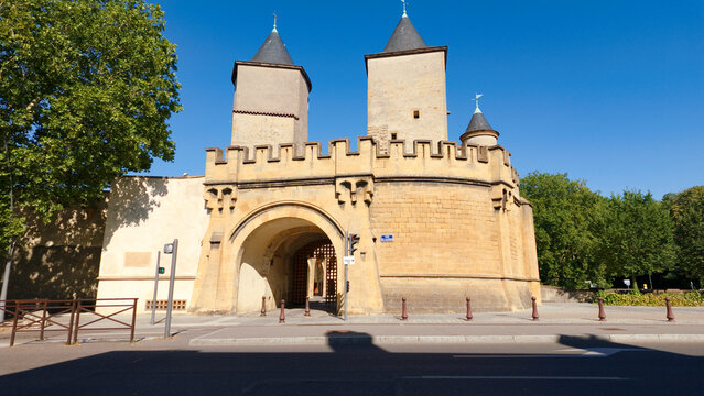 Porte des Allemands, a fortified bridge and gate, standing in Metz against a clear blue sky