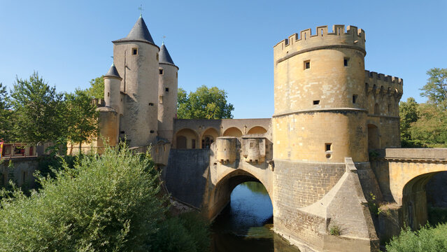 Historic Porte des Allemands gate and bridge spanning river in Metz, France