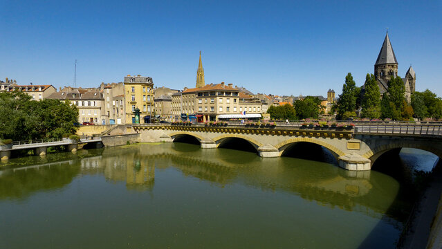 Metz cityscape featuring the Temple Neuf, bridges, and reflections on the Moselle River