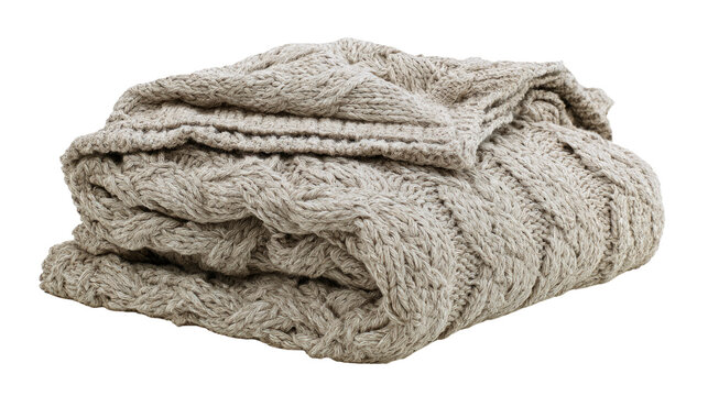 Folded beige cable knit wool blanket isolated on transparent background as png file for digital projects