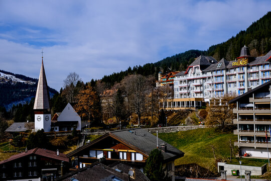 Wengen, Switzerland - March 13, 2026. A picturesque daytime landscape view of the car-free mountain village of Wengen, Switzerland, showcasing the historic multi-story Palace Hotel building on the hil