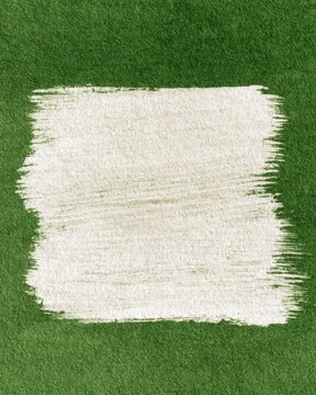 White rectangular paint brushstroke on green textured surface for design, poster, background and eco stationery layout