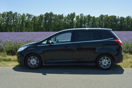 Provence, France - Jul 18, 2014: Ford CMax сar on the local tar road along lavender field. Plateau of Sault most popular region for travel in Provence, France