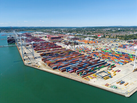 Southampton, United Kingdom - 31 July 2026: Aerial view of the Port of Southampton featuring rows of colorful shipping containers, gantry cranes, and cargo ships docked along the waterfront.