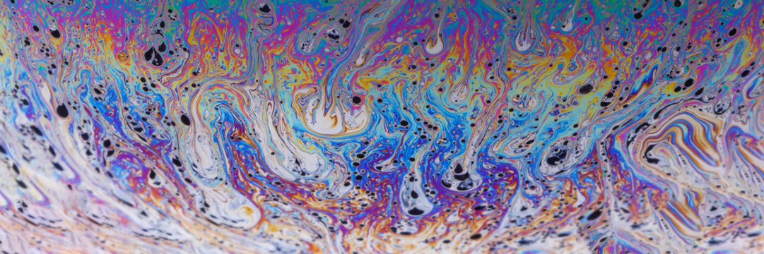 Painterly soap bubble surface with vibrant magenta, turquoise and indigo ridges, full of motion and intricate microstructure.