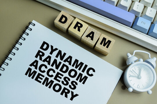 Concept of DRAM - Dynamic Random Access Memory on book isolated on Wooden Table.