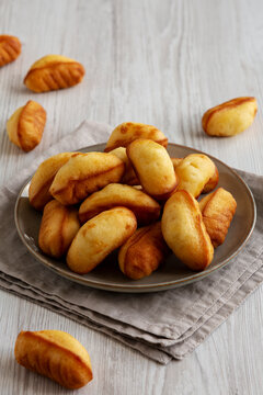 Homemade Sweet French Mini Madeleines on a Plate, side view.