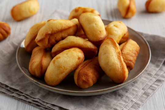 Homemade Sweet French Mini Madeleines on a Plate, side view.