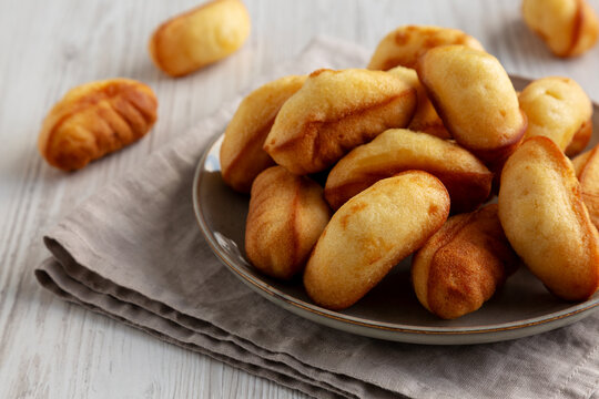 Homemade Sweet French Mini Madeleines on a Plate, side view.