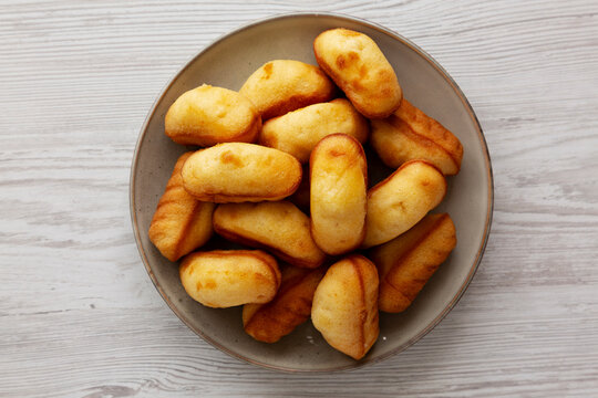 Homemade Sweet French Mini Madeleines on a Plate, top view.