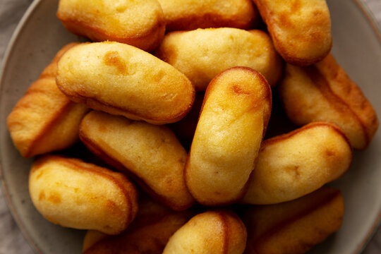 Homemade Sweet French Mini Madeleines on a Plate, top view.