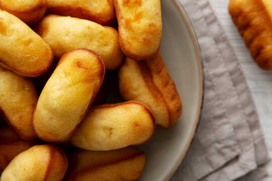 Homemade Sweet French Mini Madeleines on a Plate, top view.