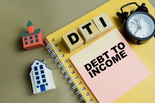 Concept of DTI - Debt To Income write on sticky notes isolated on Wooden Table.