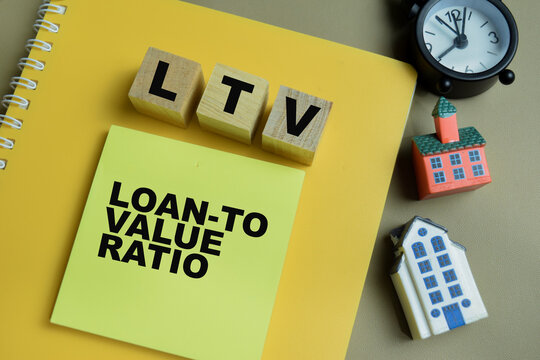 Concept of LTV - Loan-To Value Ratio write on sticky notes isolated on Wooden Table.