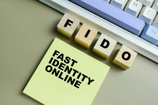 Concept of FIDO - Fast Identity Online write on sticky notes isolated on Wooden Table.