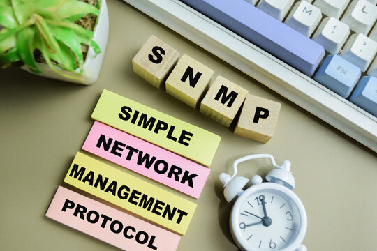 Concept of SNMP - Simple Network Management Protocol write on sticky notes isolated on Wooden Table.