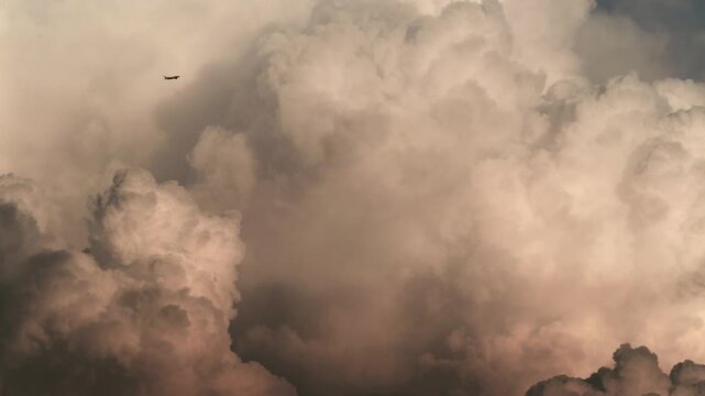 Tokyo,Japan -August 14, 2026: A climbing airplane bypassing cumulonimbus clouds