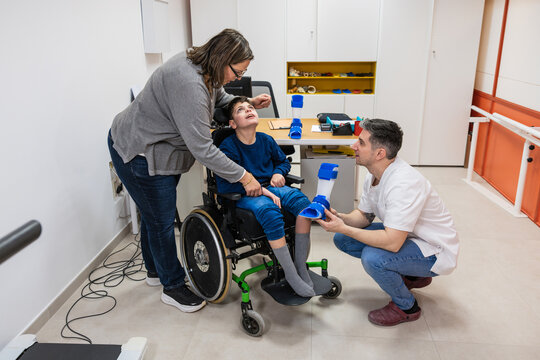 Child receiving dafo orthosis fitting at rehabilitation center