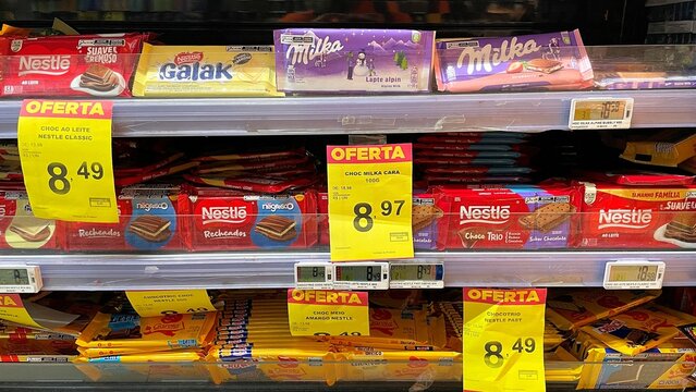 Salvador, Brazil - August 14, 2026: Various brands of chocolate bars including Nestle, Garoto, Milka, and Galak on a supermarket shelf in Brazil. 