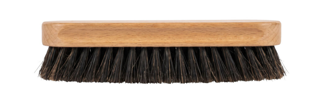 Wooden handled brush with dark bristles for cleaning and polishing