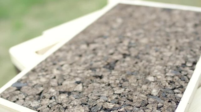 Close up of a coarse textured stone slab on a wooden crate