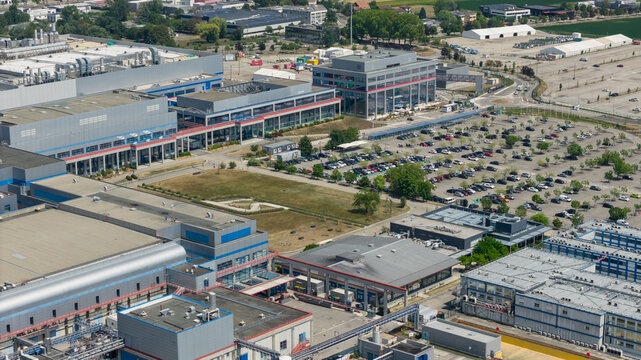 Crolles, Auvergne-Rhone-Alpes, France - 01 August 2026: Aerial view of the STMicroelectronics semiconductor campus featuring industrial buildings, research facilities, and large parking lots.