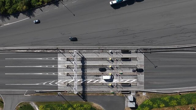 Aerial view of highway toll plaza with cars driving and paying toll