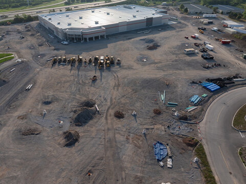 Buffalo, New York, United States - 19 July 2026: Aerial view of the Costco construction site featuring heavy machinery, piles of dirt, and building materials on a large cleared lot.