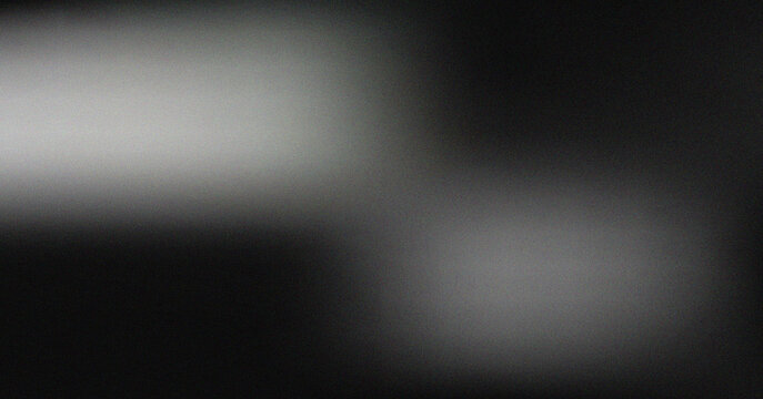 Elegant dark monochromatic gradient with soft light diffusion and realistic grainy film texture surface effect