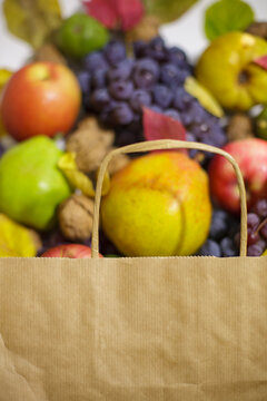 Craft paper bag mockup with large copy space for logo and blurred fruit harvest