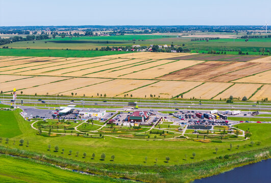Nowy Dwor Mazowiecki, Poland - 02 August 2026: Aerial view of Droga Ekspresowa S7 highway service area with parking, restaurant facilities, and surrounding agricultural fields.