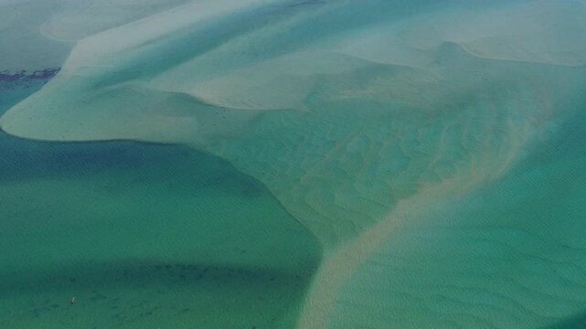 Currents from the North Atlantic Ocean continuously shape the sand banks and beaches of Cape Cod, Massachusetts. The entire peninsula is in constant movement due to its geologic makeup of mostly sand.