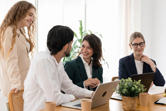Diverse business team collaborating and discussing in office meeting