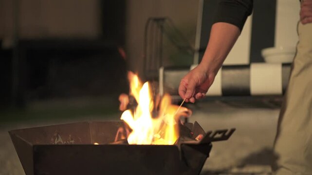 Marshmallow toasts above a backyard fire pit outside a home in Mendoza.