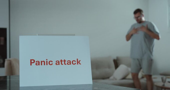 Man experiencing a panic attack at home. Ideal for mental health, anxiety, stress, and emotional wellbeing concepts.