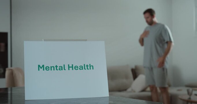 Man experiencing anxiety at home with a mental health awareness concept. Ideal for stress, wellbeing, and emotional health topics.