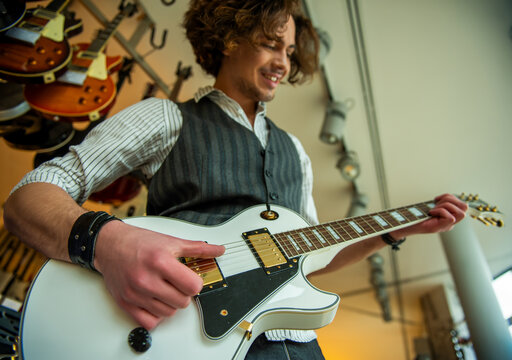 Playing White Electric Guitar.