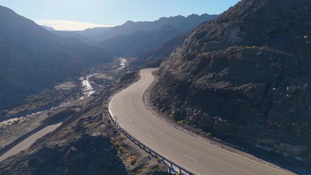 Drone Dolly In Follows Scenic Mountain Curve on Nacional Route 150, San Juan, Argentina, Arid Landscape
