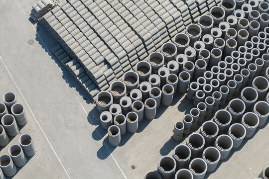 Tarnow, Poland - 31 July 2026: Aerial view of the Bruk-Bet production plant featuring rows of stacked concrete pipes in an industrial yard.