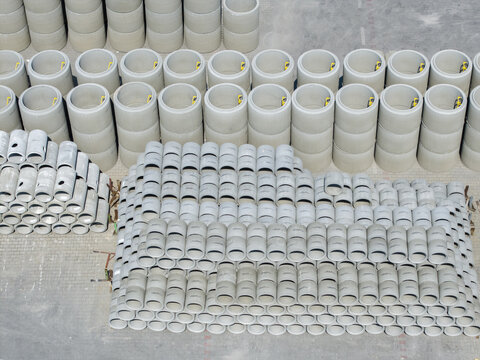 Tarnow, Poland - 31 July 2026: Aerial view of the Bruk-Bet production facility with rows of stacked concrete pipes and rings in the industrial yard.