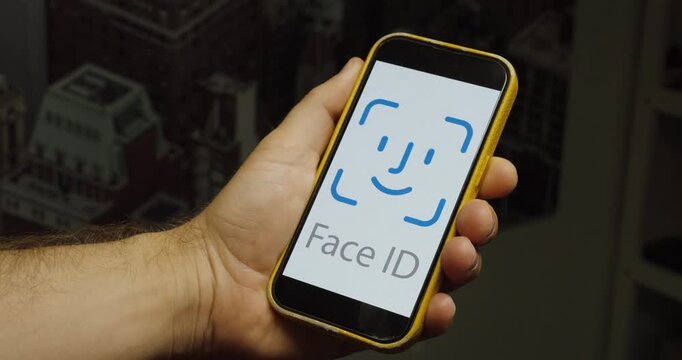 Close-up of a smartphone displaying a Face ID authentication request. Ideal for biometric security, identity verification, and mobile access concepts.